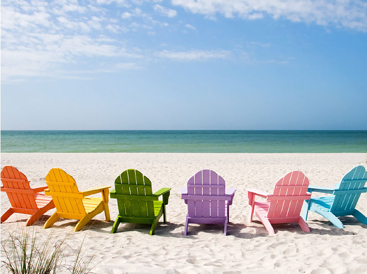 summer retreat - colorful chairs on the beach